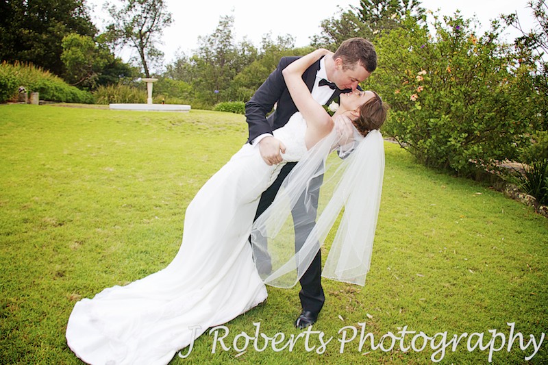 groom gives bride a romantic dip and sexy kiss - wedding photography sydney